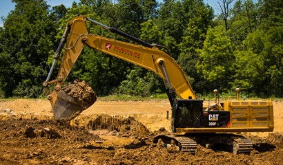 CAT Excavator digging at dirt